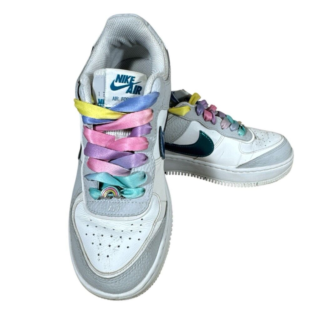 Nike Kids White Sneakers with Teal Swoosh and Pastel Rainbow Laces